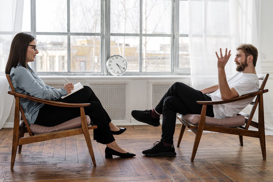 pexels-photo-4101143-4101143 A therapist engaging in a counseling session with a male patient to support mental health.