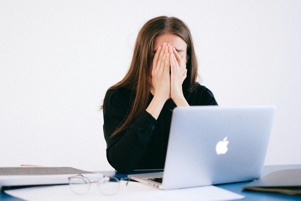 pexels-photo-4226215-4226215 Woman feeling stressed and overwhelmed at her desk while working remotely on a laptop.